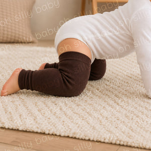 Baby crawling in a white long sleeve bodysuit wearing Bearly Brown baby leg warmers