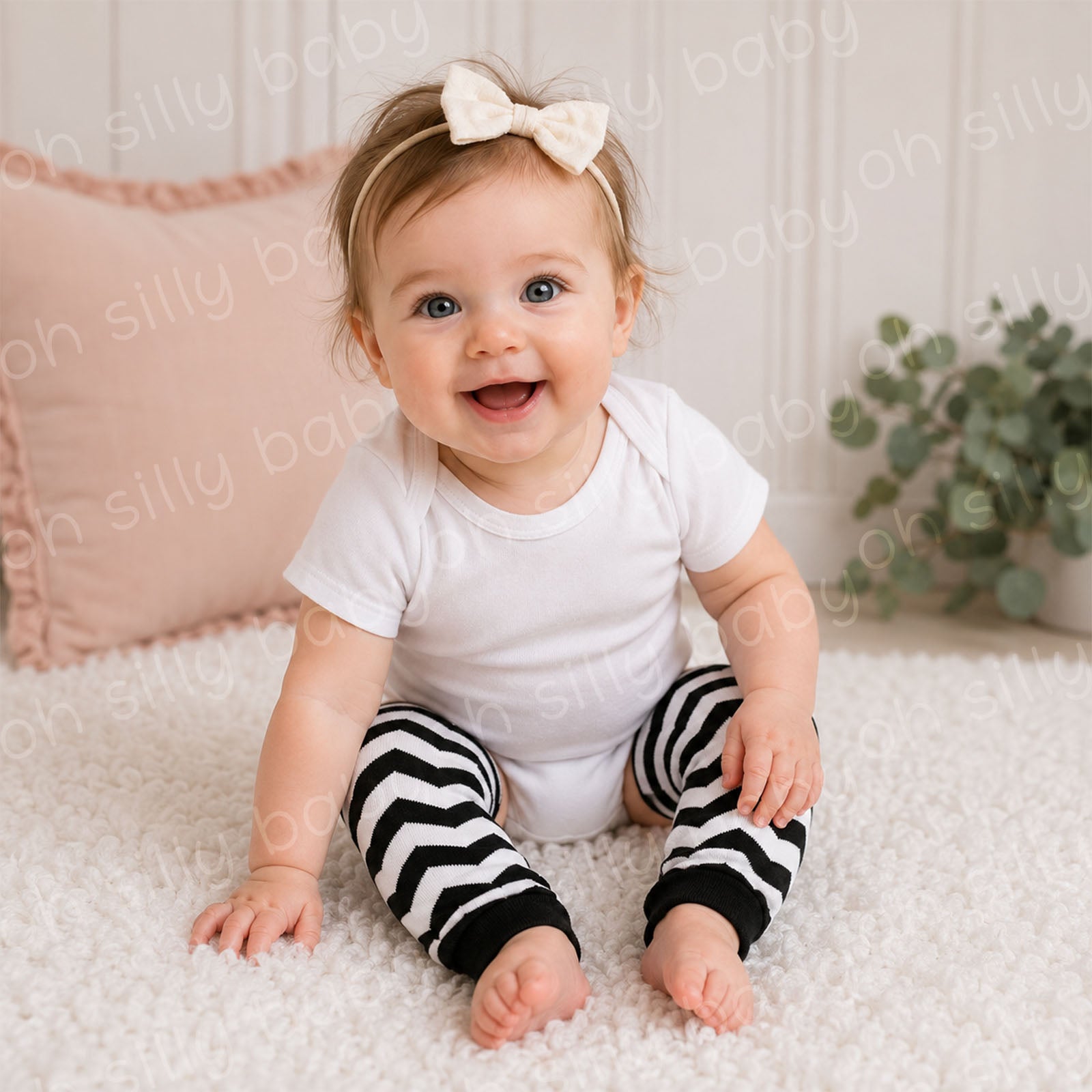 Baby wearing a white short sleeve bodysuit with Black and White Chevron baby leg warmers