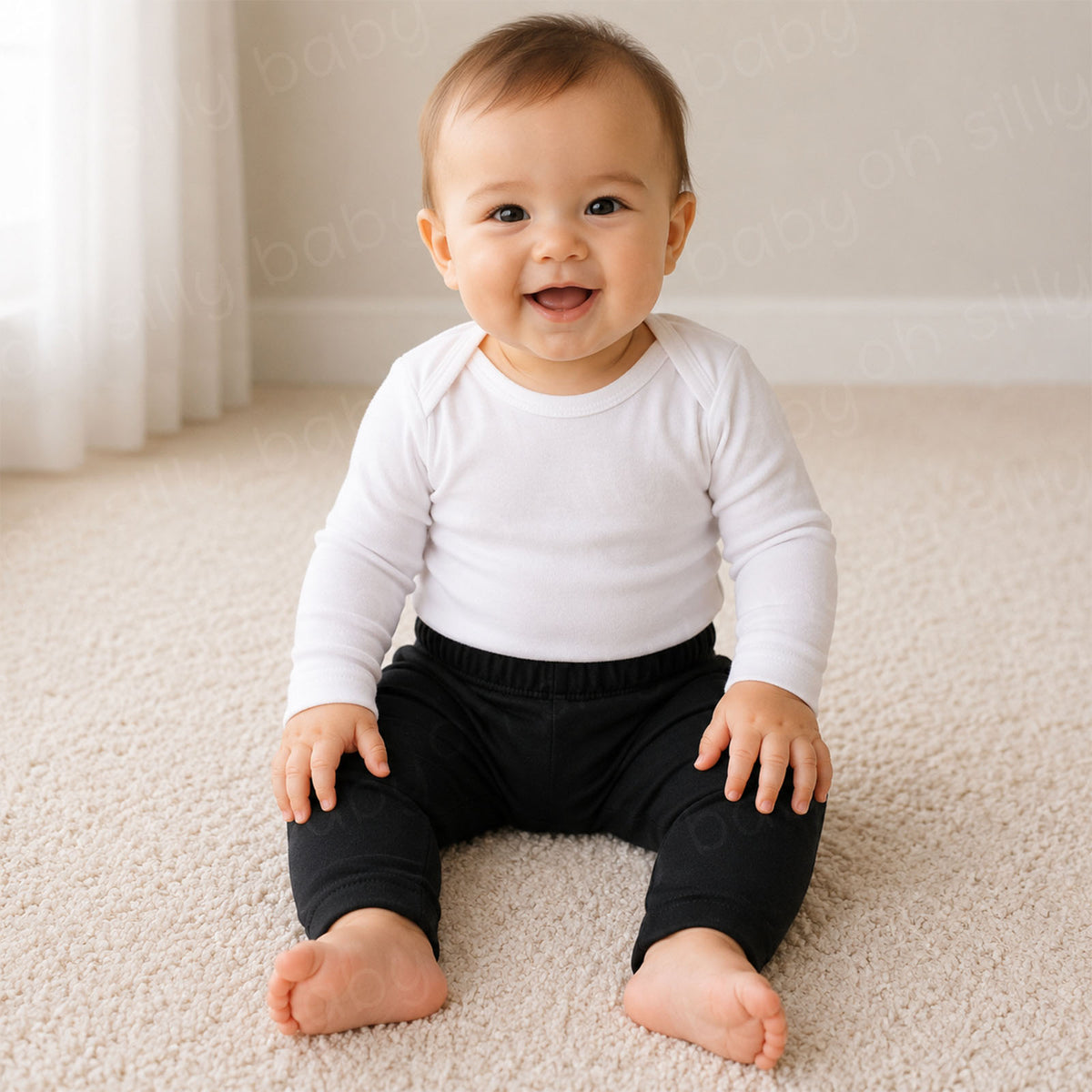A baby sitting while wearing Black Cotton Pants with a white long sleeve baby bodysuit