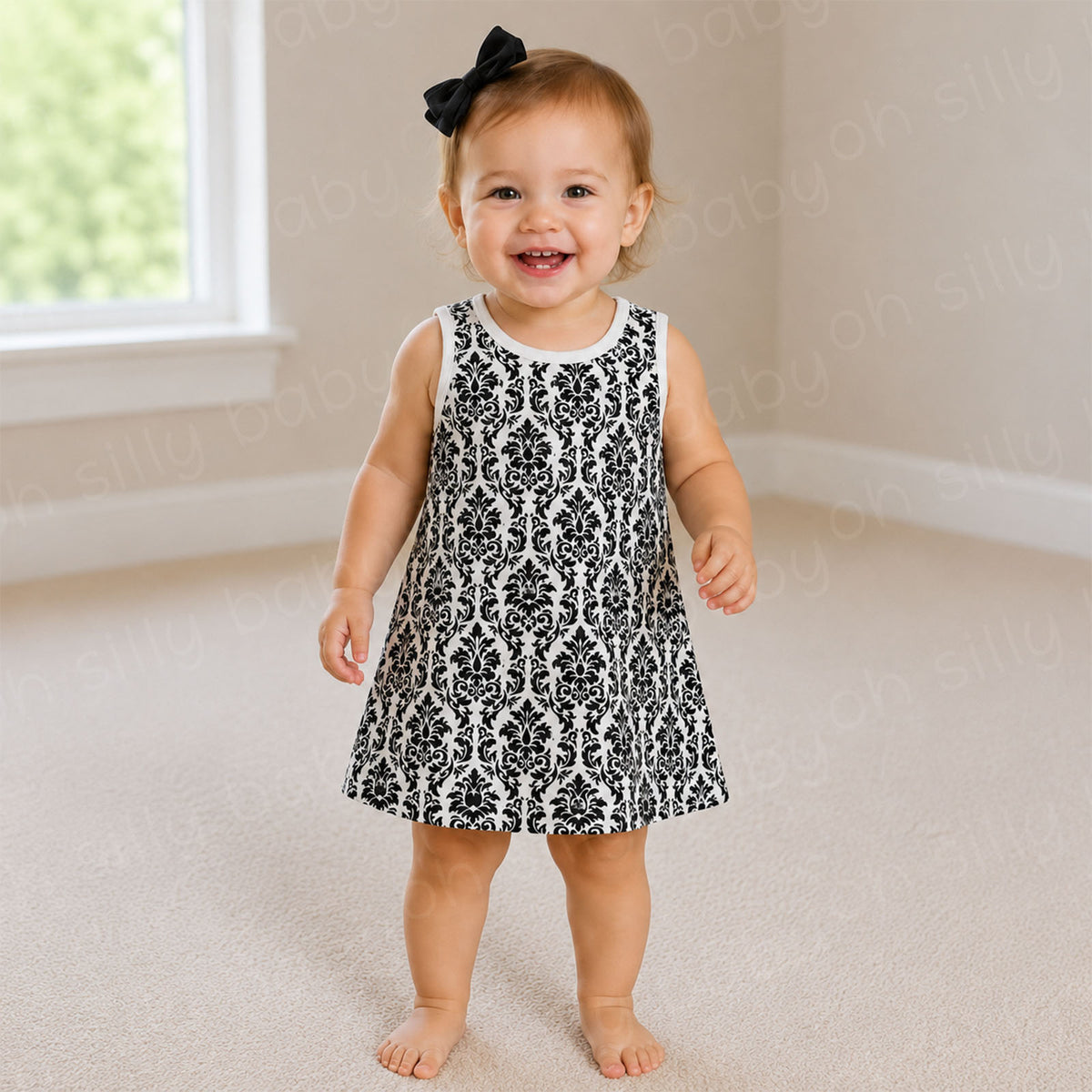 Toddler girl wearing a black and white damask print dress