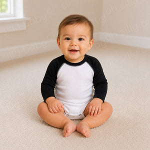 Baby wearing a black and white long sleeve raglan baby bodysuit
