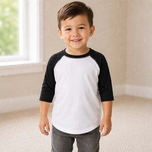 Toddler boy wearing a black and white raglan toddler t-shirt