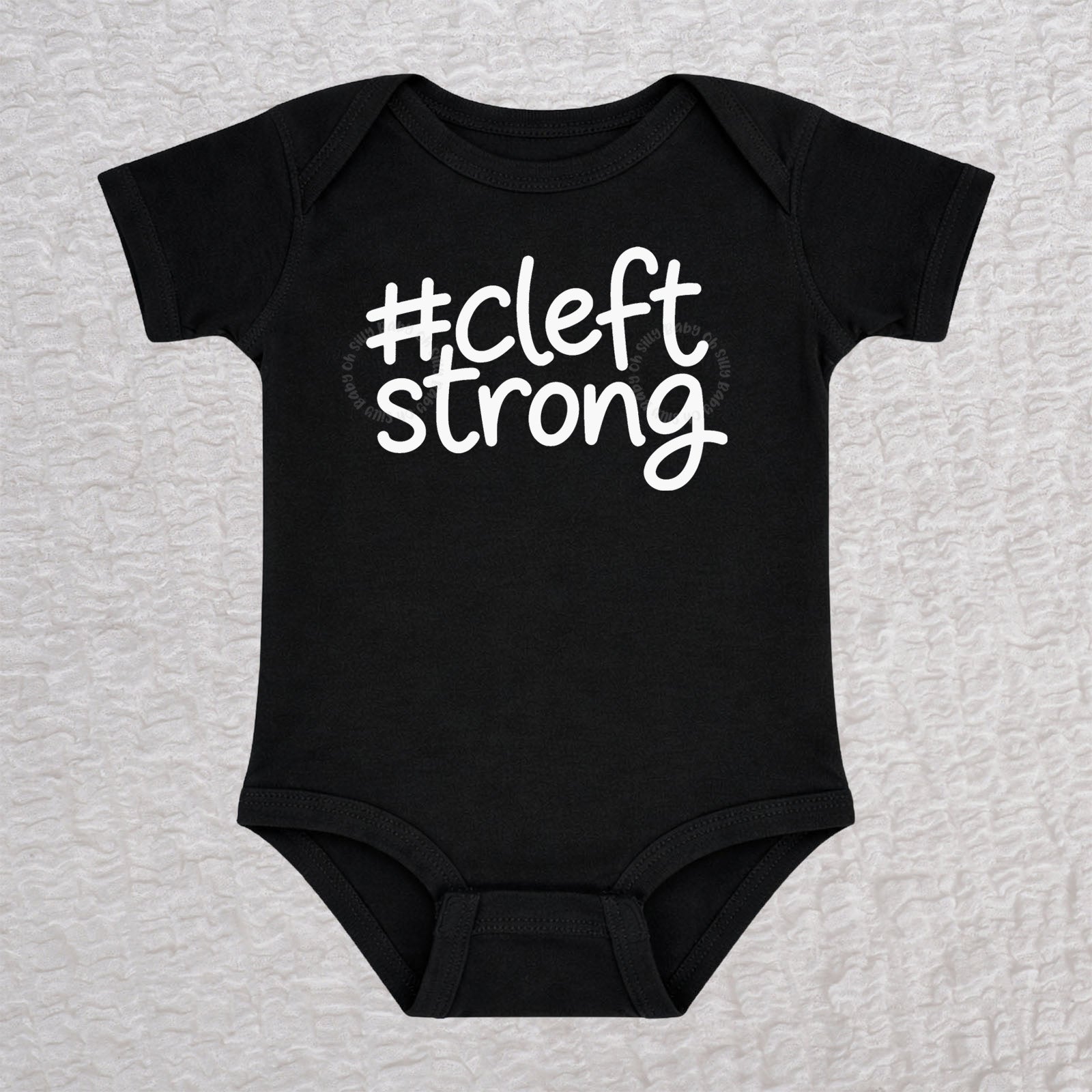 Cleftstrong short sleeve baby bodysuit in black with white #cleftstrong design