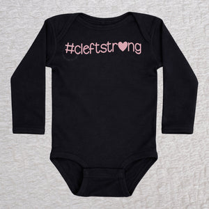 Cleftstrong Heart long sleeve baby bodysuit in black featuring a pink Cleftstrong heart design