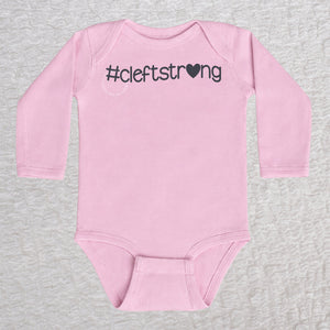 Cleftstrong Heart long sleeve baby bodysuit in pink featuring a pink Cleftstrong heart design