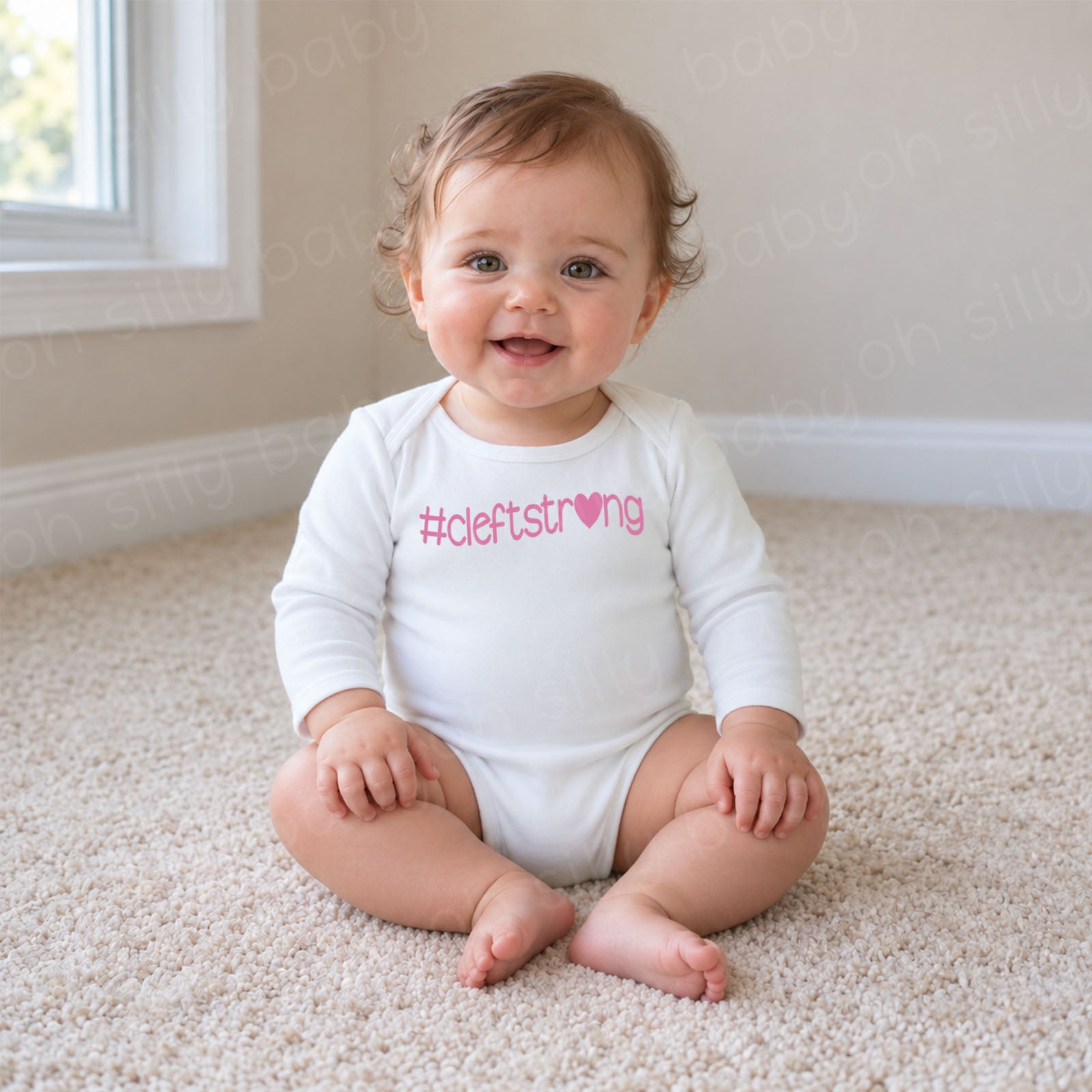 Cleftstrong Heart baby wearing white long sleeve bodysuit with pink #cleftstrong heart design