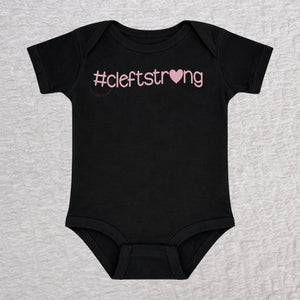 Cleftstrong Heart short sleeve baby bodysuit in black featuring a pink Cleftstrong heart design