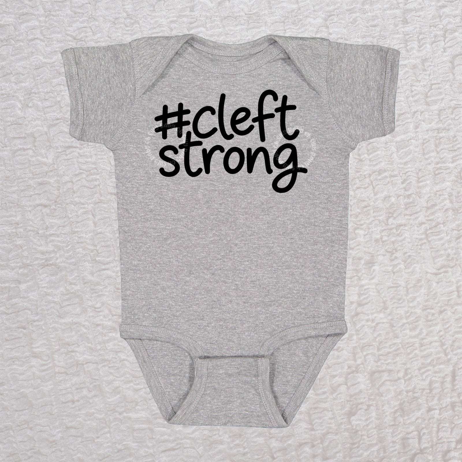 Cleftstrong short sleeve baby bodysuit in heather gray with black #cleftstrong design