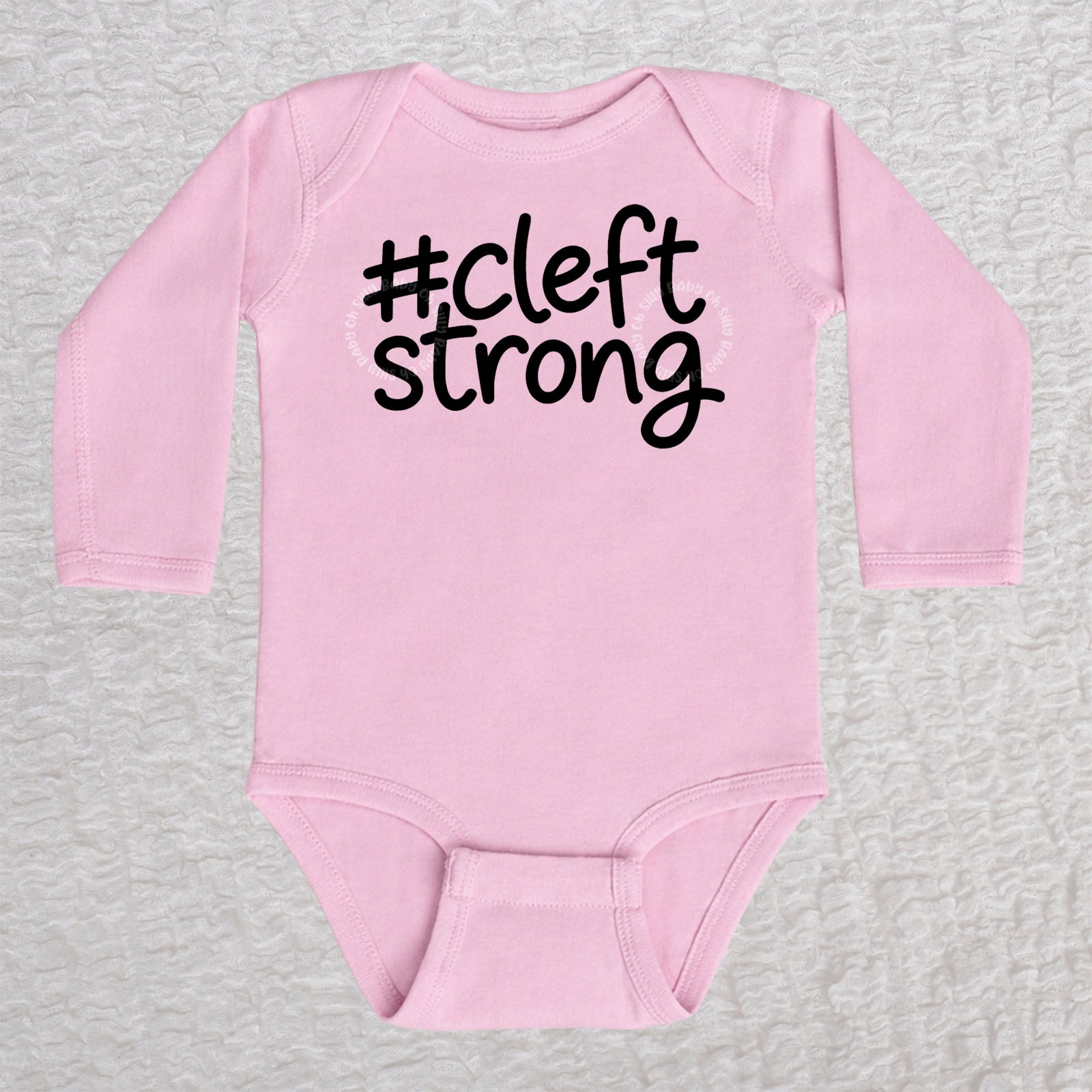 Cleftstrong long sleeve baby bodysuit in pink with black #cleftstrong design