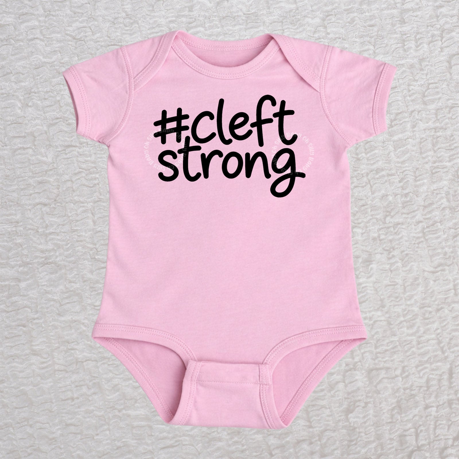 Cleftstrong short sleeve baby bodysuit in pink with black #cleftstrong design