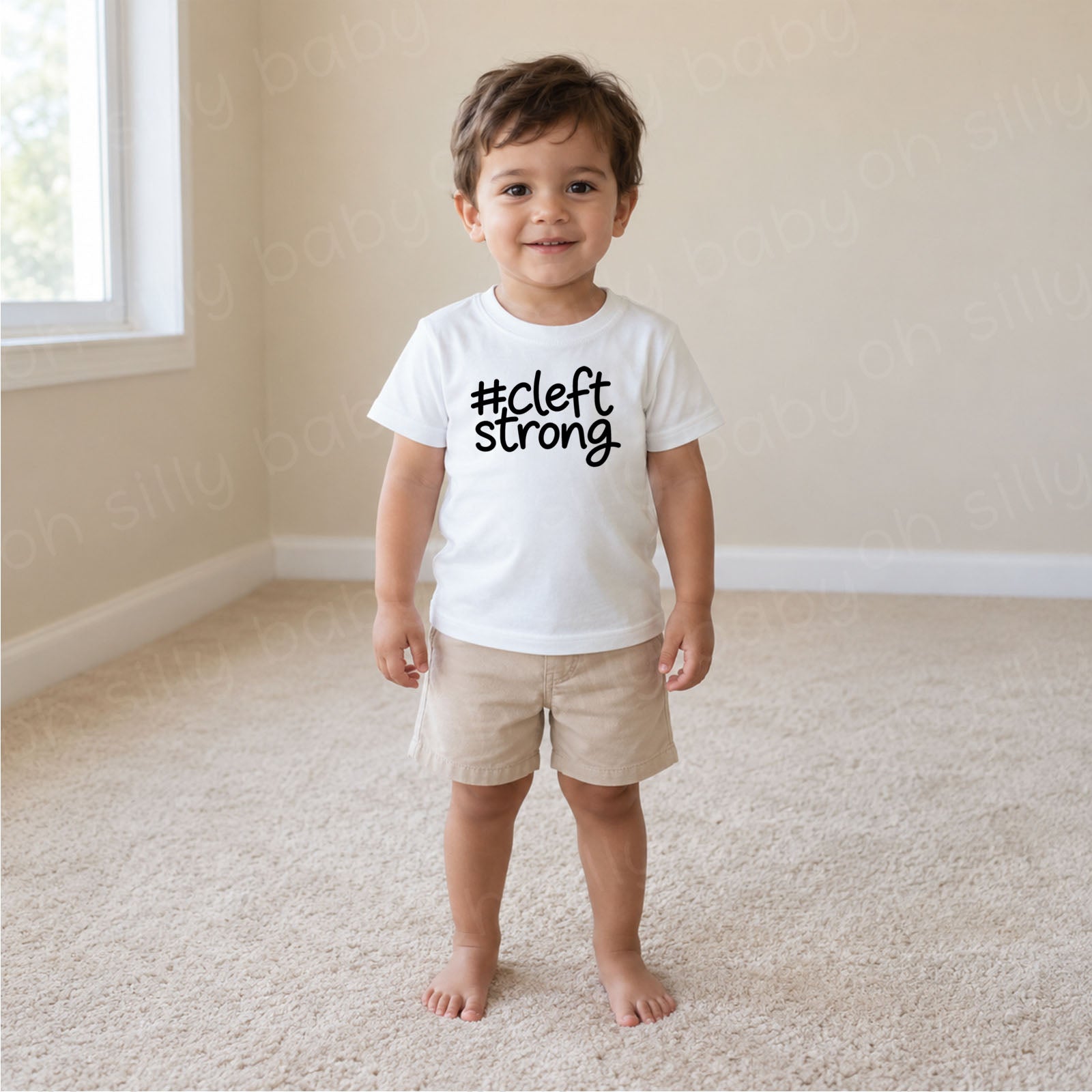 Cleftstrong child wearing white unisex baby and toddler T-shirt with black #cleftstrong design