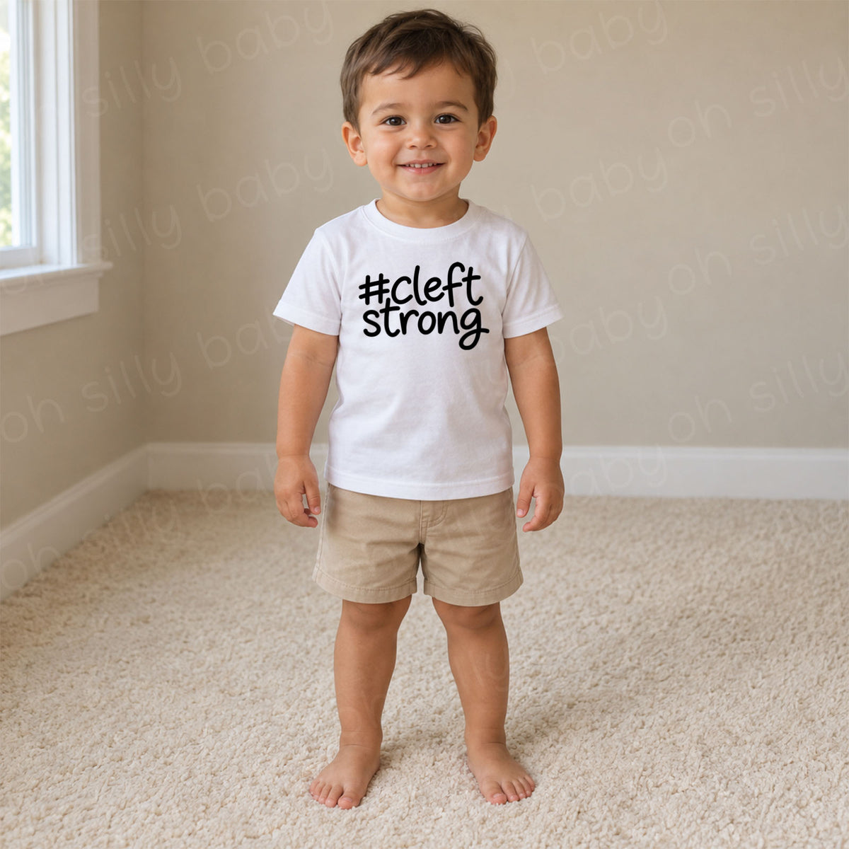 Cleftstrong child wearing white unisex baby and toddler T-shirt with black #cleftstrong design