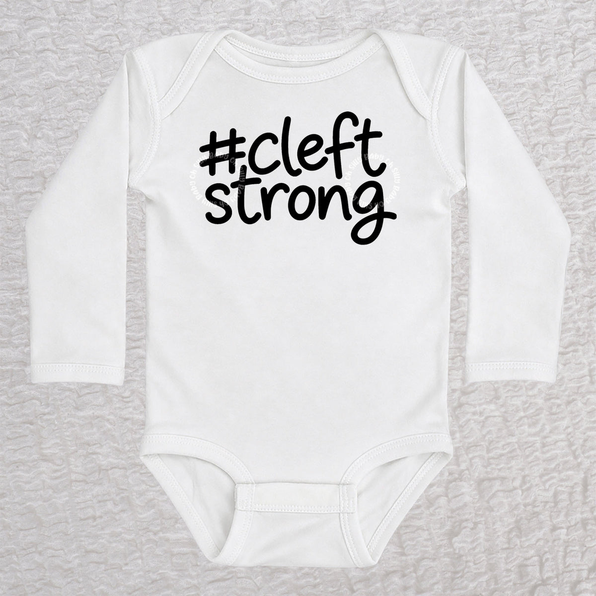 Cleftstrong long sleeve baby bodysuit in white with black #cleftstrong design