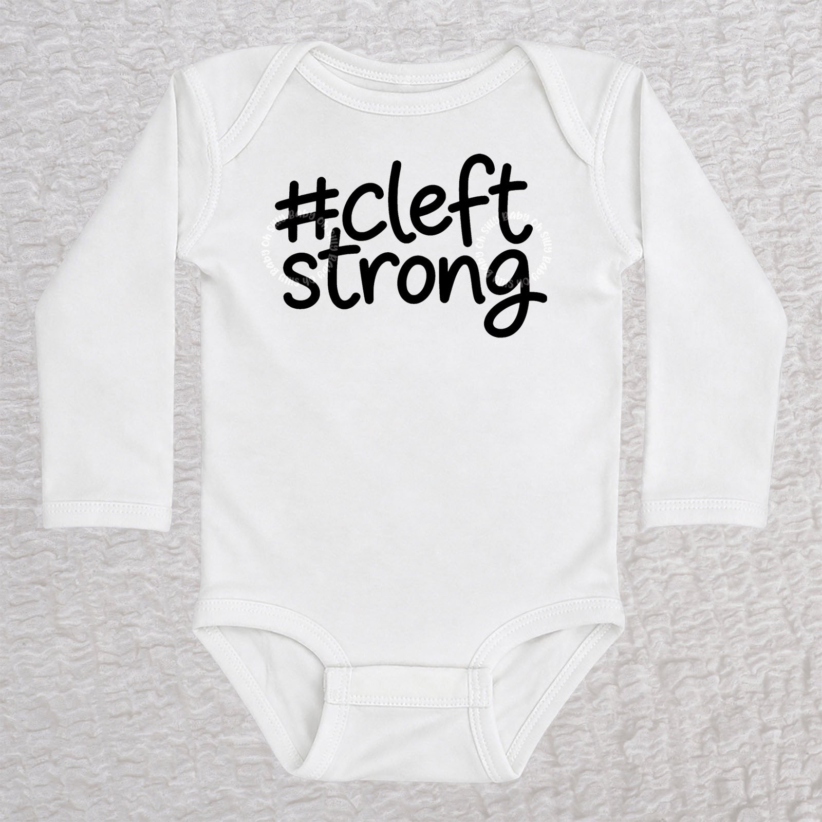 Cleftstrong long sleeve baby bodysuit in white with black #cleftstrong design