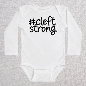 Cleftstrong long sleeve baby bodysuit in white with black #cleftstrong design