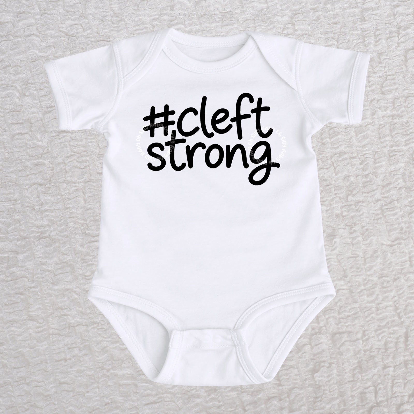 Cleftstrong short sleeve baby bodysuit in white with black #cleftstrong design
