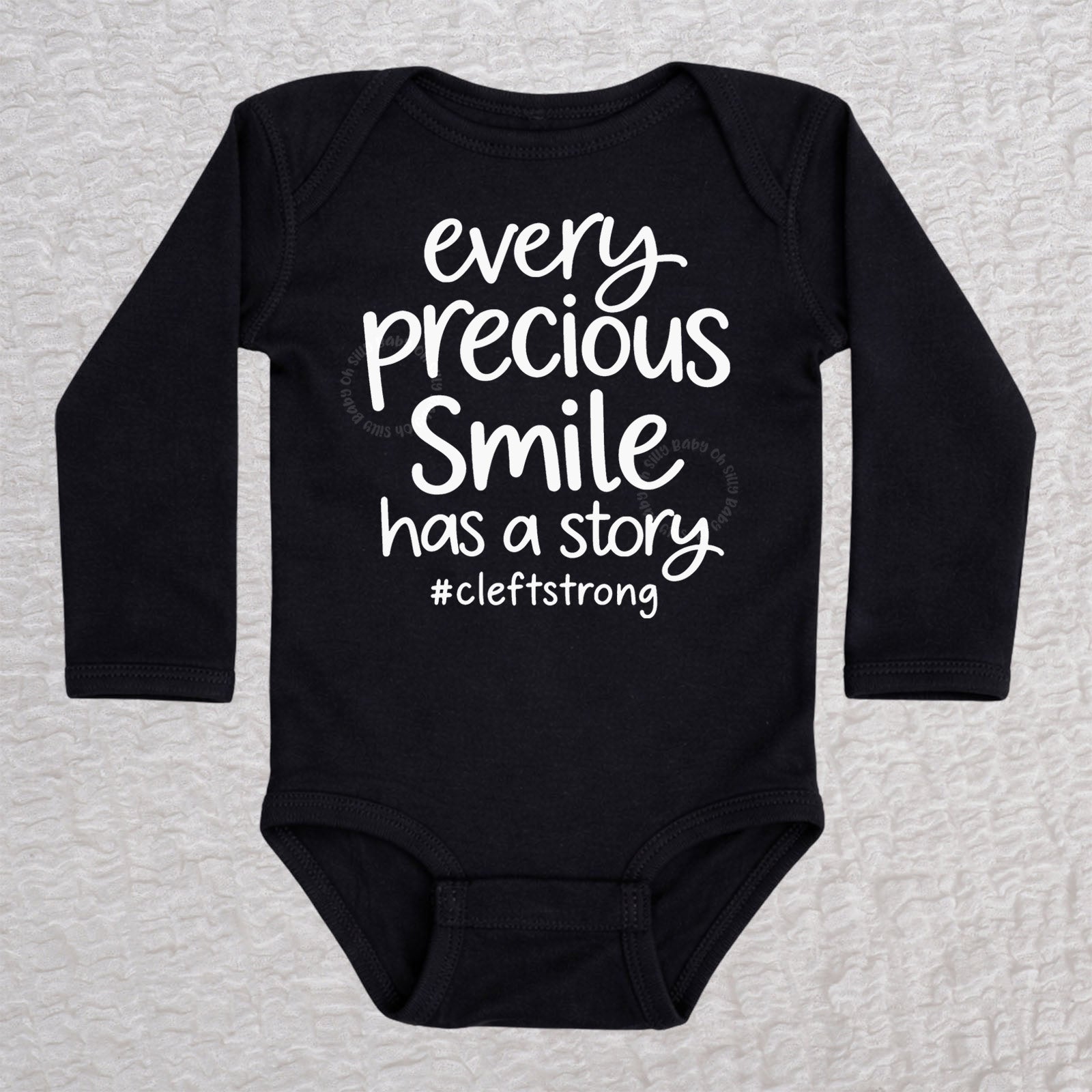 Every Precious Smile Has A Story long sleeve baby bodysuit in black with white #cleftstrong design