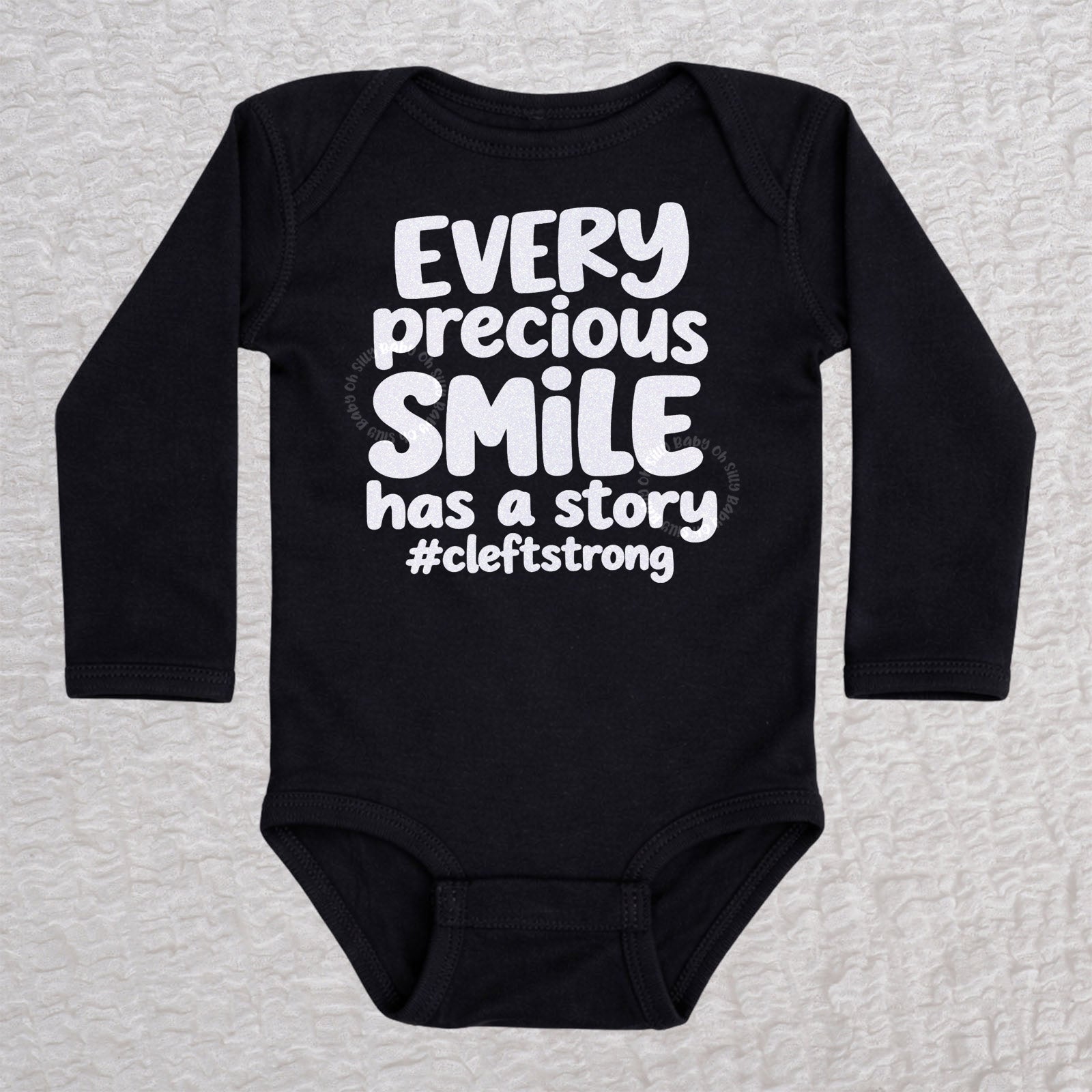 Every Precious Smile Has A Story long sleeve baby bodysuit in black with rainbow white glitter #cleftstrong design