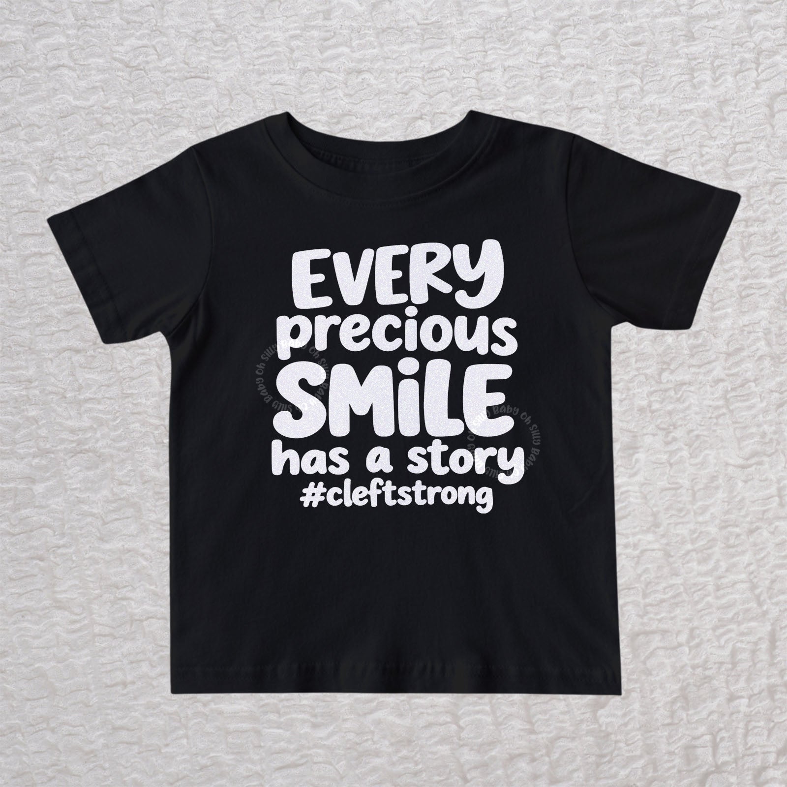 Every Precious Smile Has A Story unisex baby and toddler T-shirt in black with rainbow white glitter #cleftstrong design