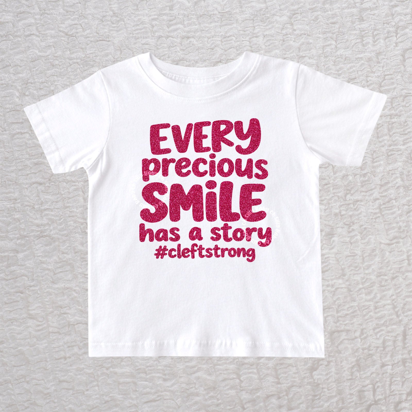 Every Precious Smile Has A Story unisex baby and toddler T-shirt in white with hot pink glitter #cleftstrong design