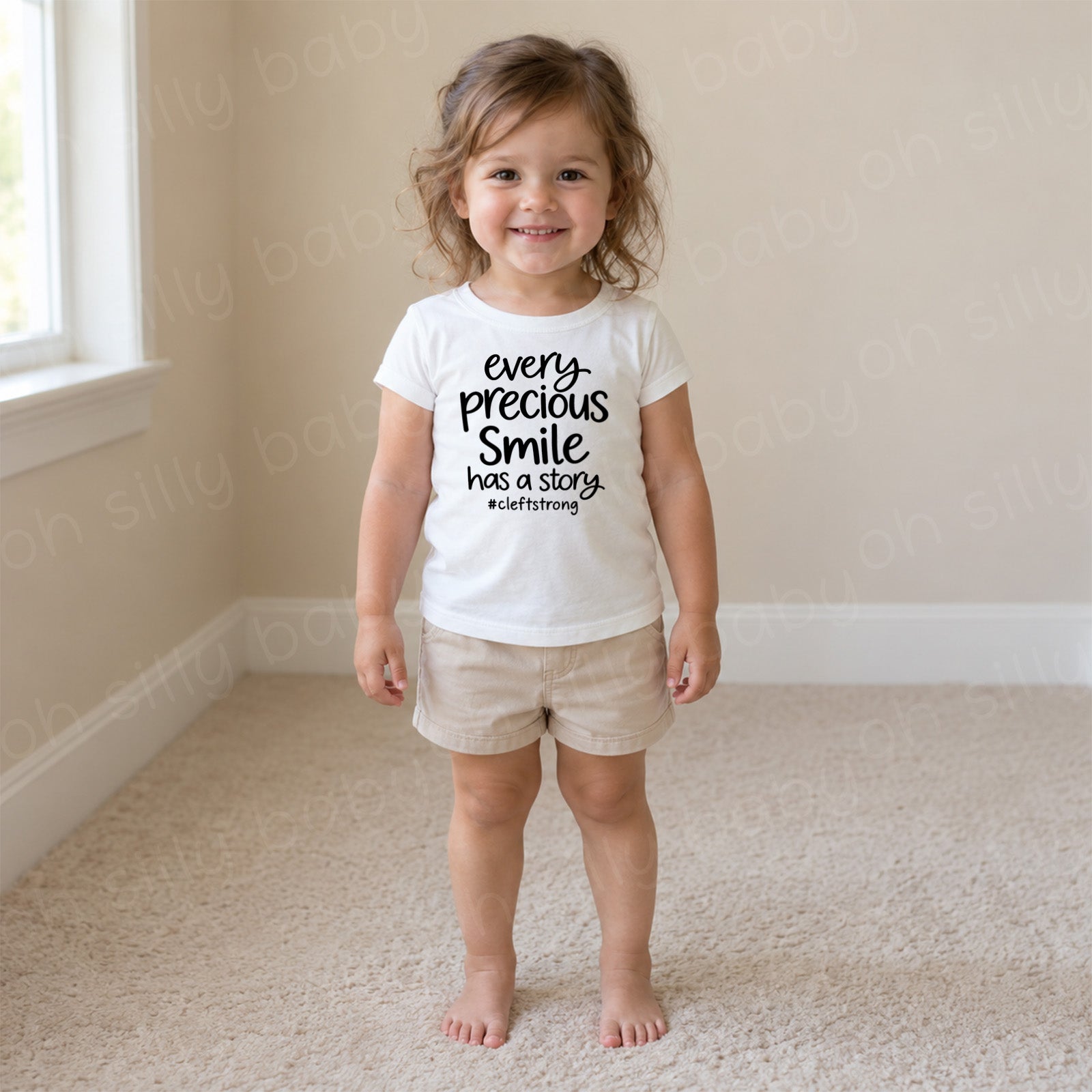 Every Precious Smile Has A Story toddler girl wearing white girls fit T-shirt with black #cleftstrong design