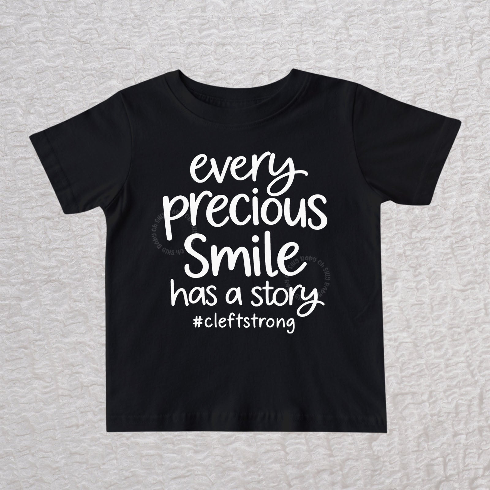 Every Precious Smile Has A Story unisex baby and toddler T-shirt in black with white #cleftstrong design