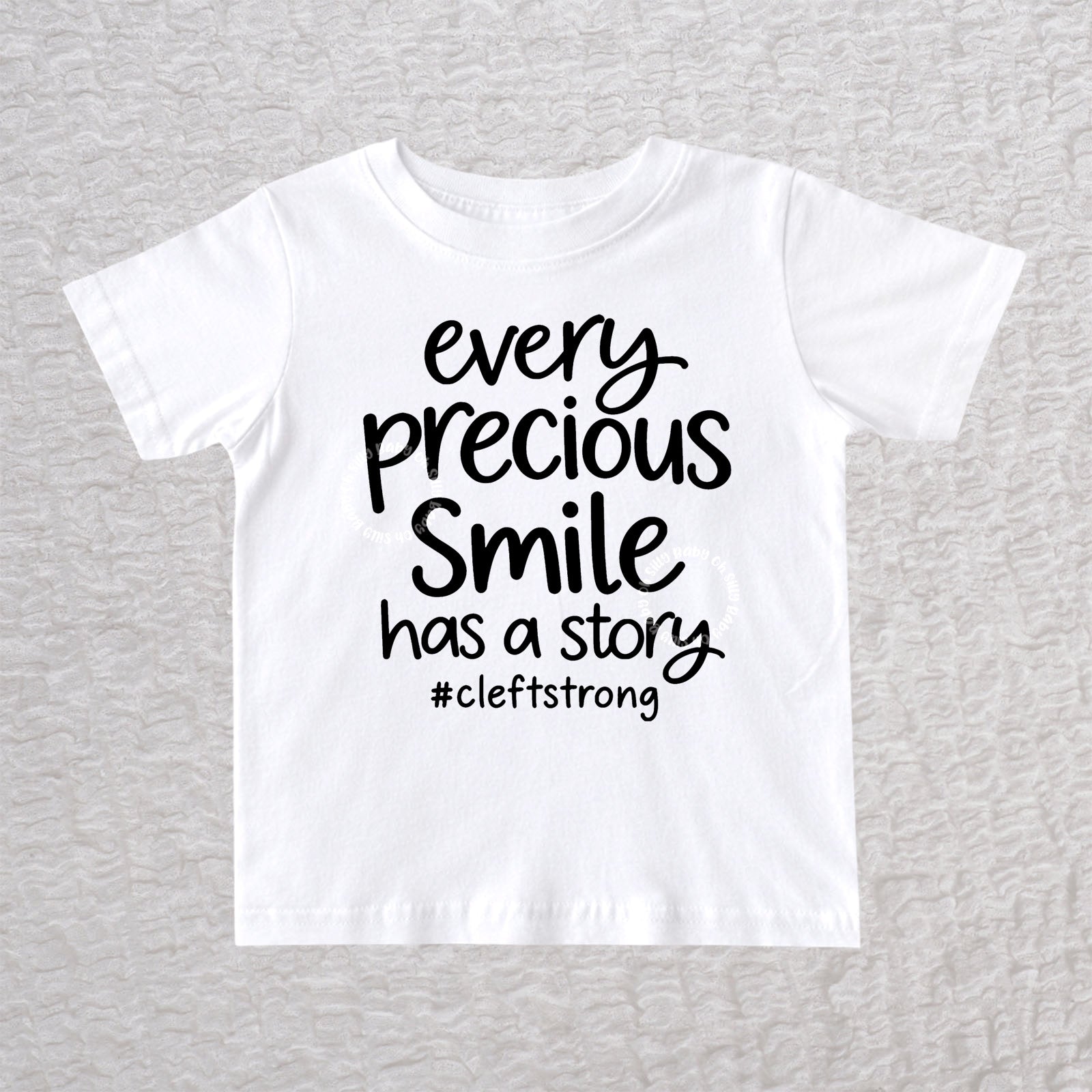 Every Precious Smile Has A Story unisex baby and toddler T-shirt in white with black #cleftstrong design