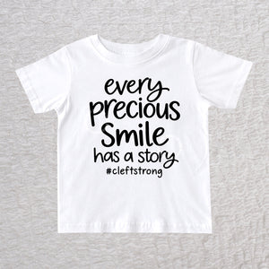 Every Precious Smile Has A Story unisex baby and toddler T-shirt in white with black #cleftstrong design