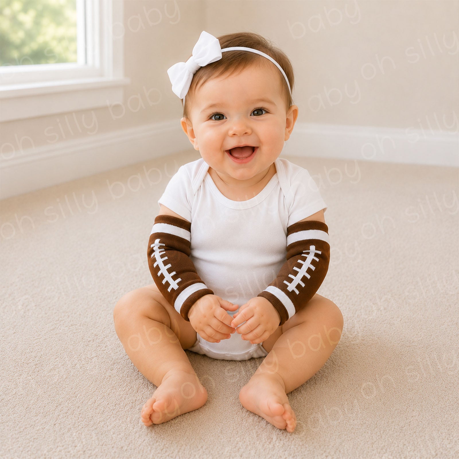 Baby wearing football baby leg warmers as arm warmers with a white baby bodysuit