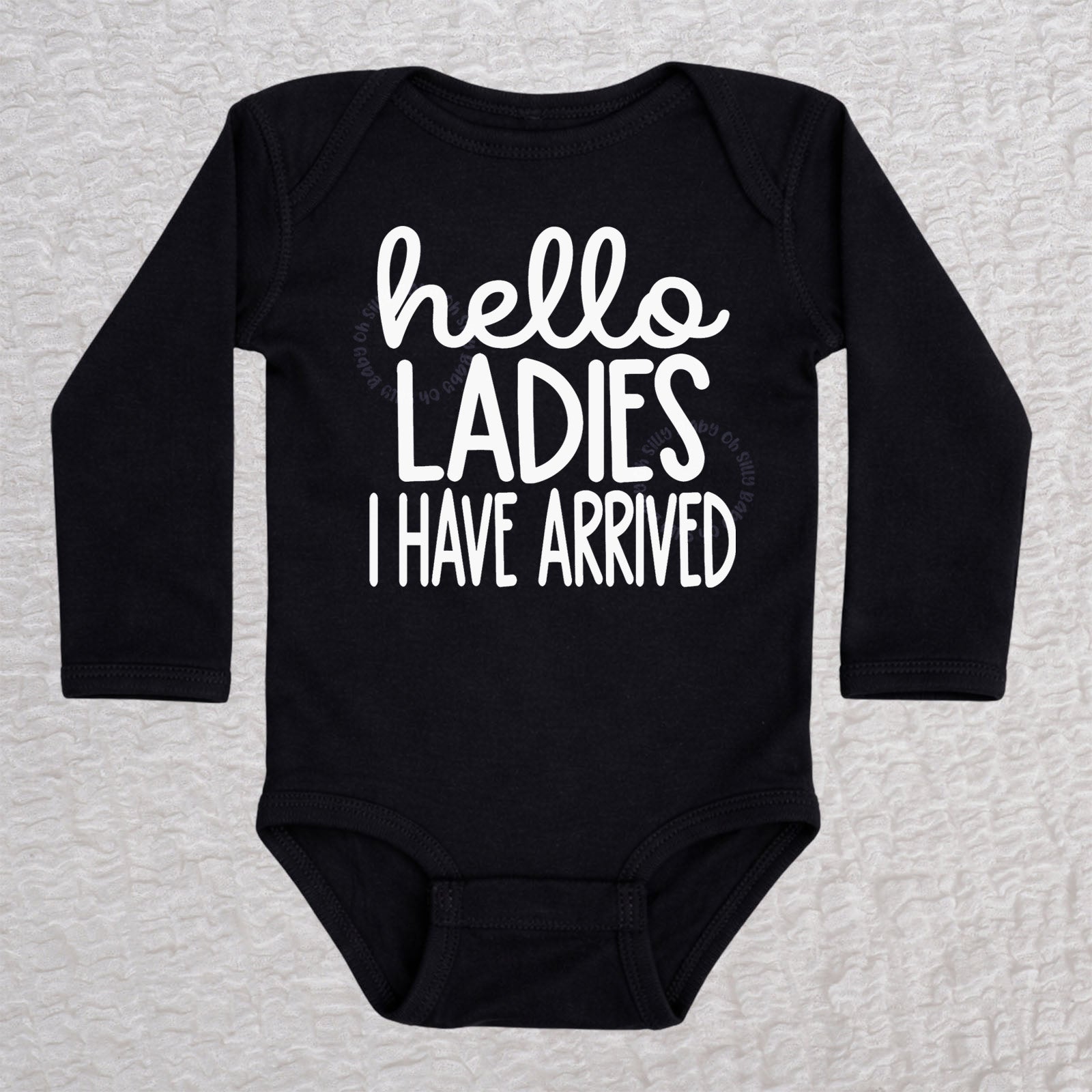 Hello Ladies I Have Arrived long sleeve baby bodysuit in black with playful typography design