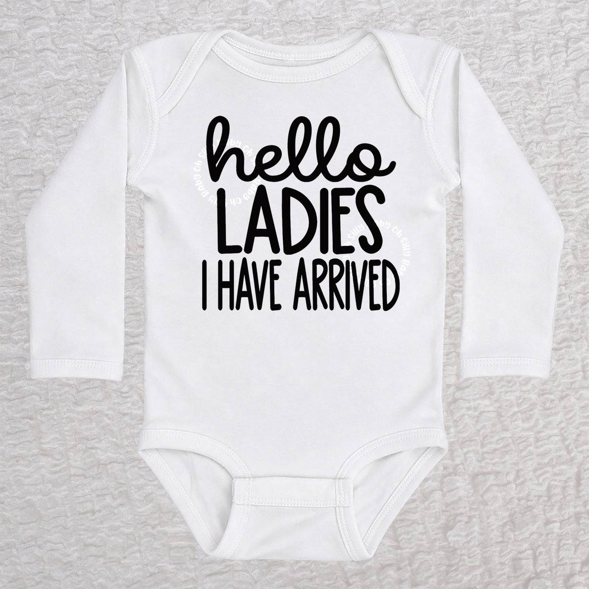 Hello Ladies I Have Arrived long sleeve baby bodysuit in white with playful typography design
