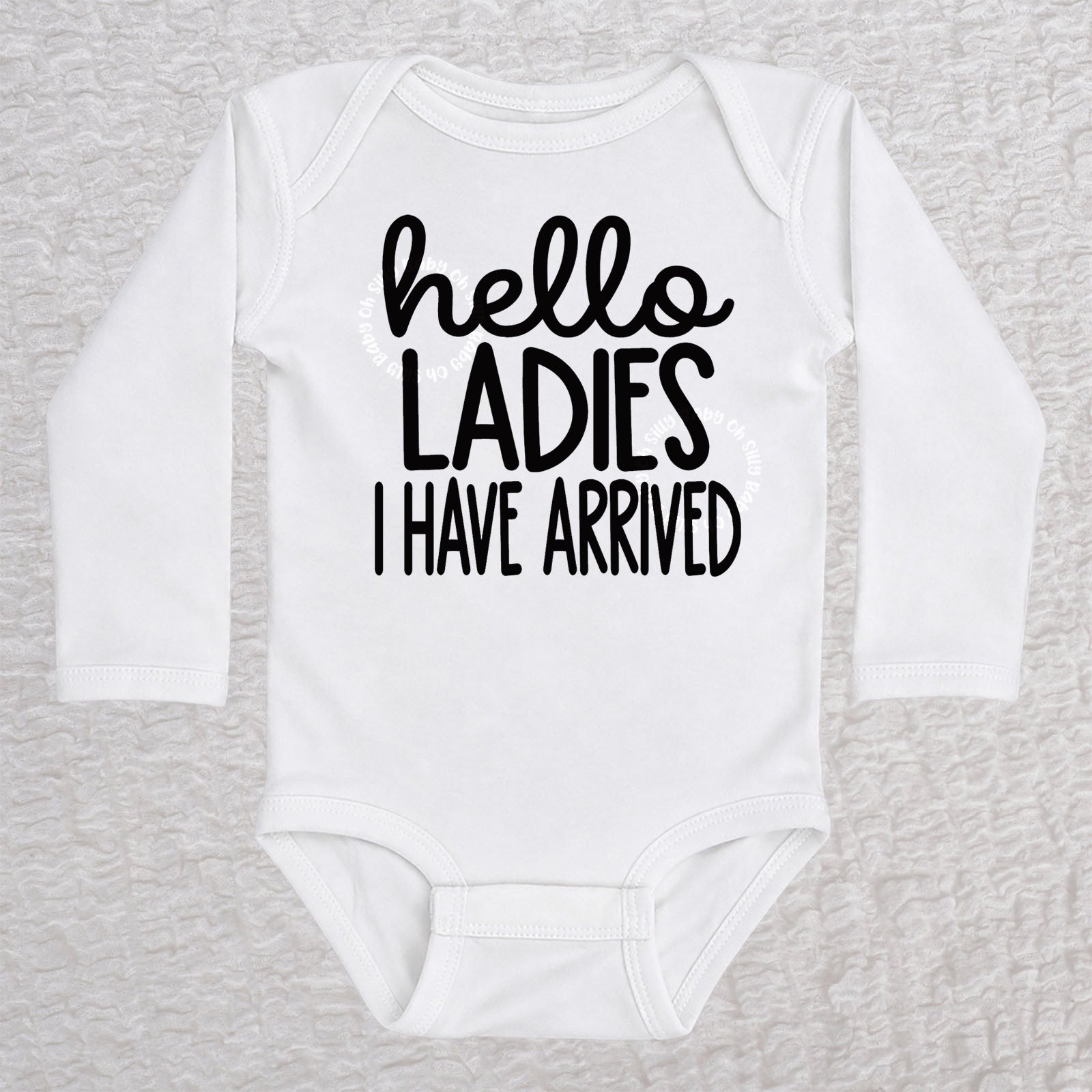 Hello Ladies I Have Arrived long sleeve baby bodysuit in white with playful typography design