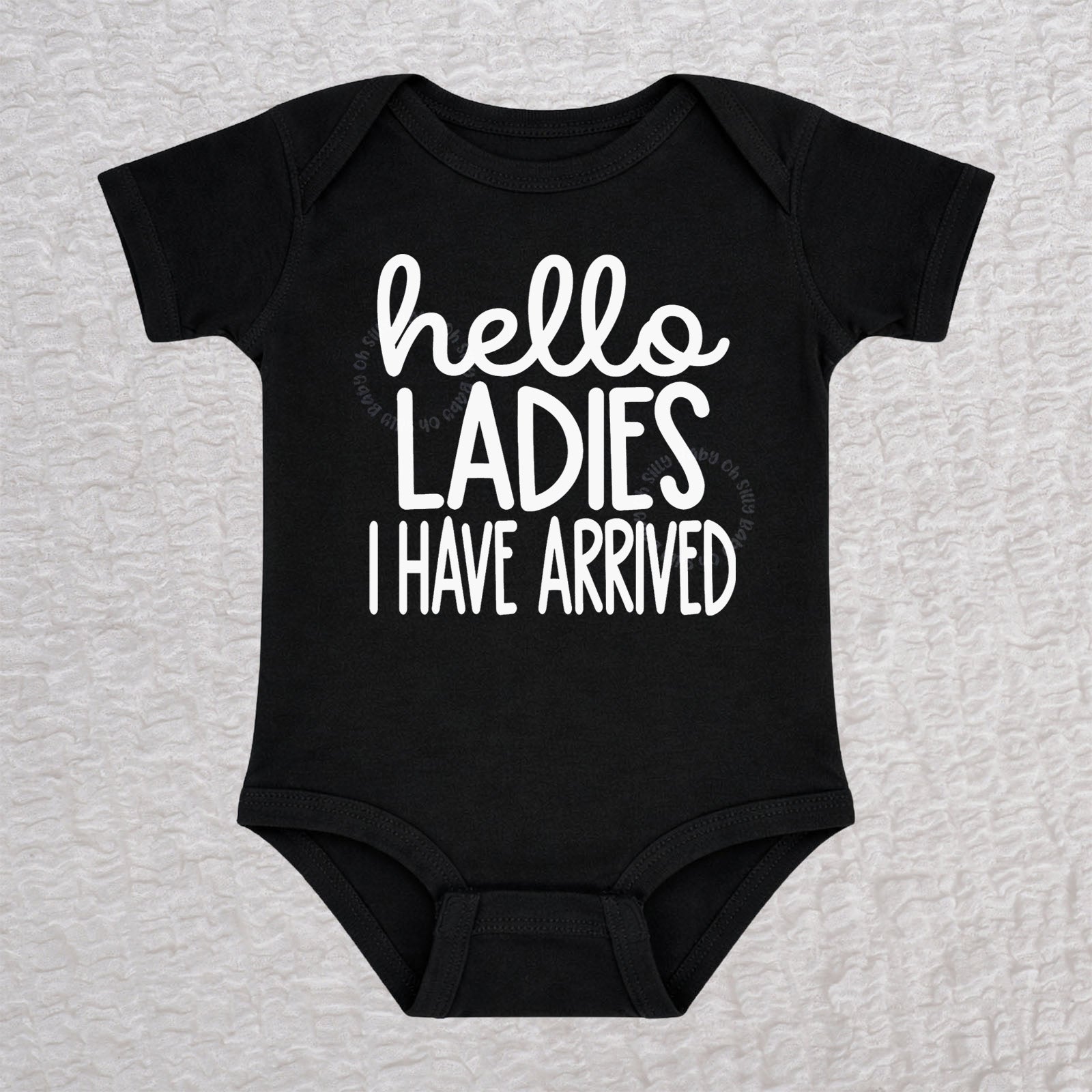 Hello Ladies I Have Arrived baby bodysuit in black with playful typography design
