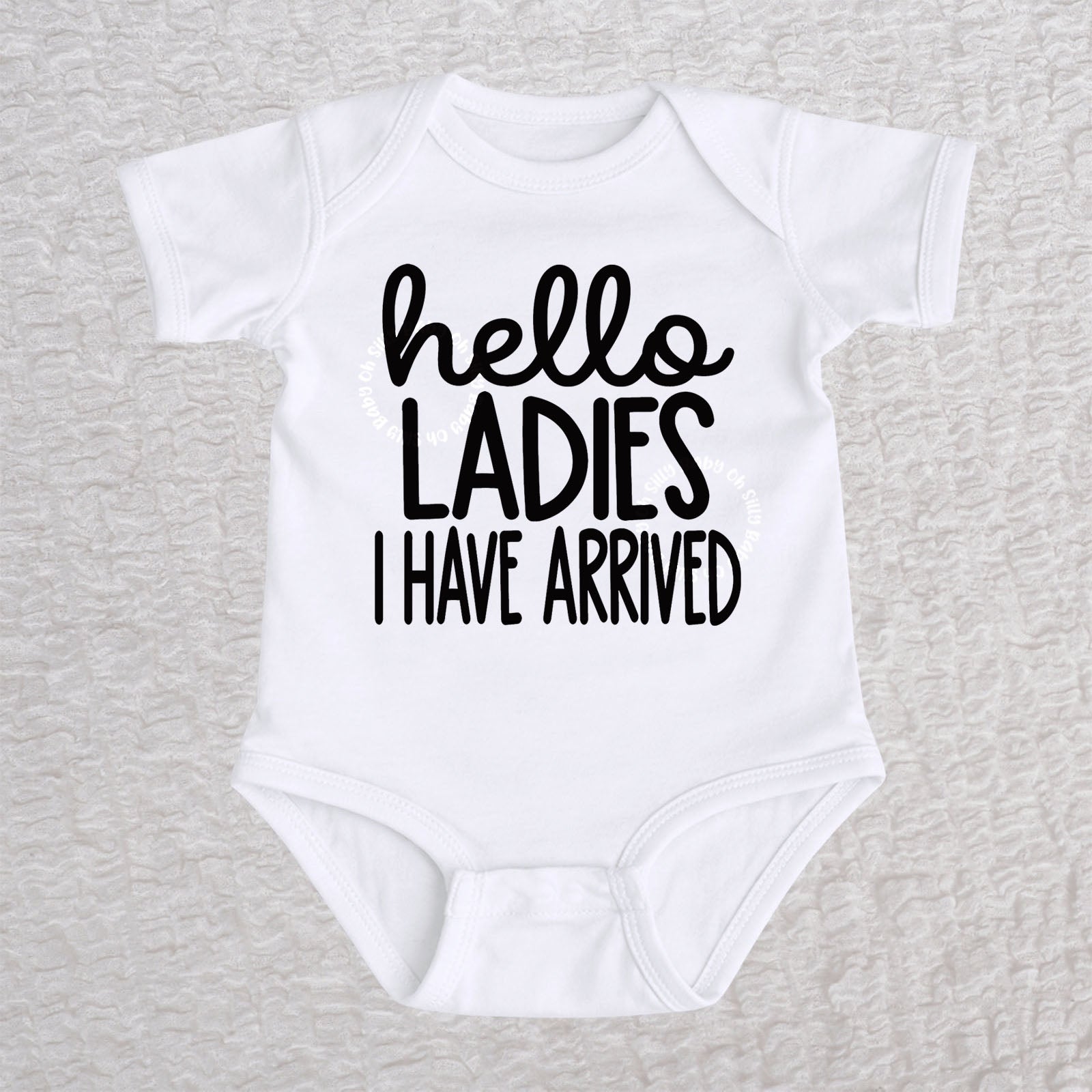 Hello Ladies I Have Arrived baby bodysuit in white with playful typography design