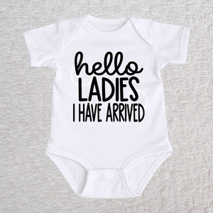 Hello Ladies I Have Arrived baby bodysuit in white with playful typography design