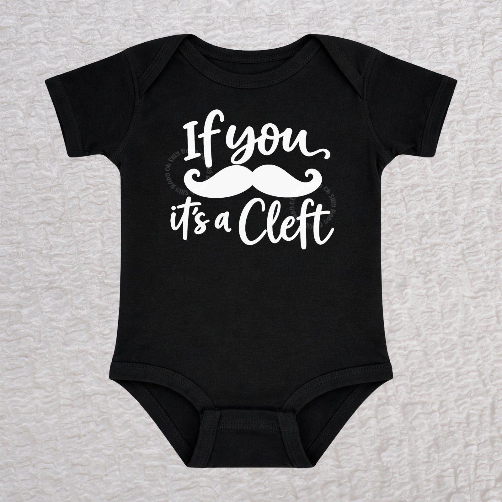 If You Mustache It's A Cleft short sleeve baby bodysuit in black with mustache design