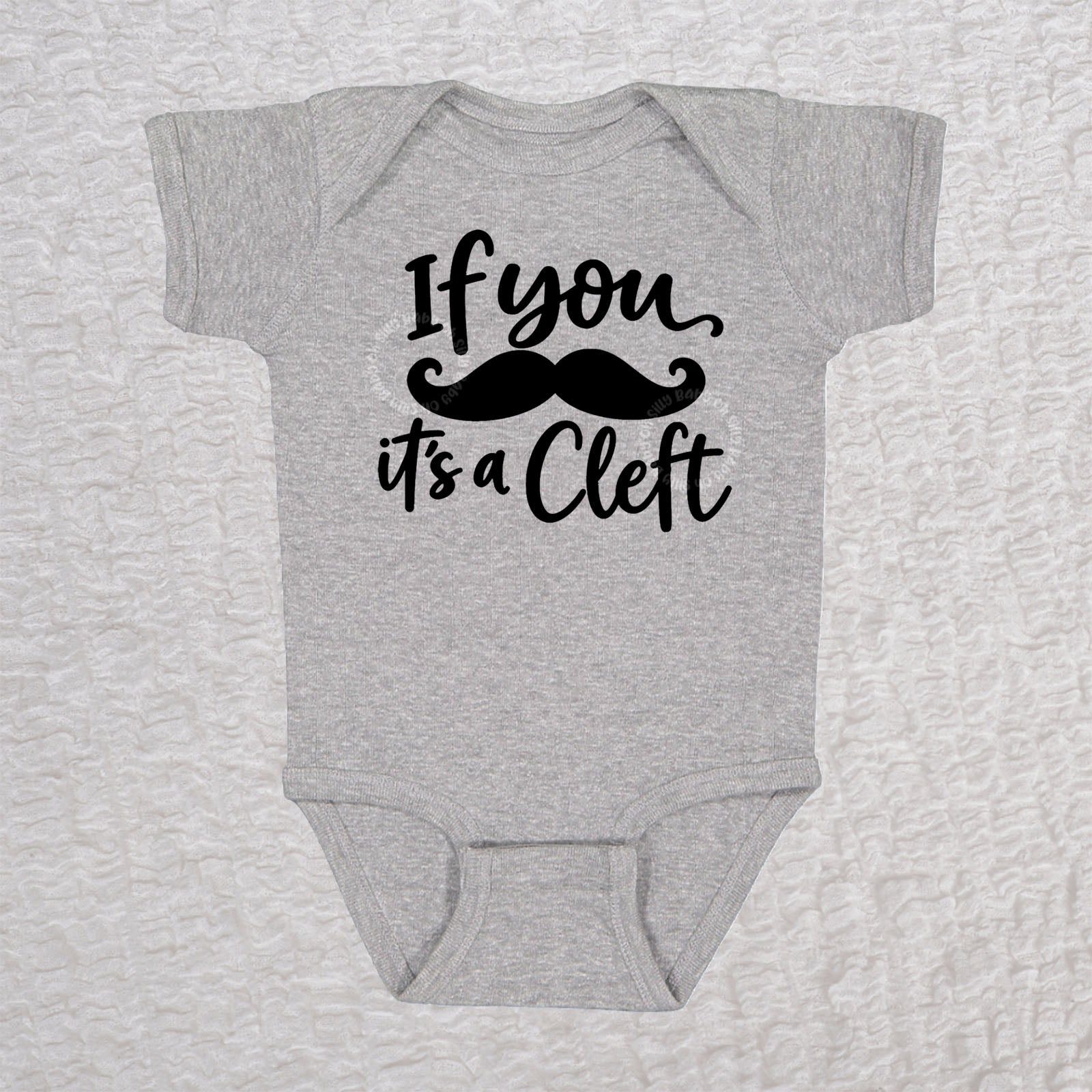 If You Mustache It's A Cleft short sleeve baby bodysuit in heather gray with black mustache design