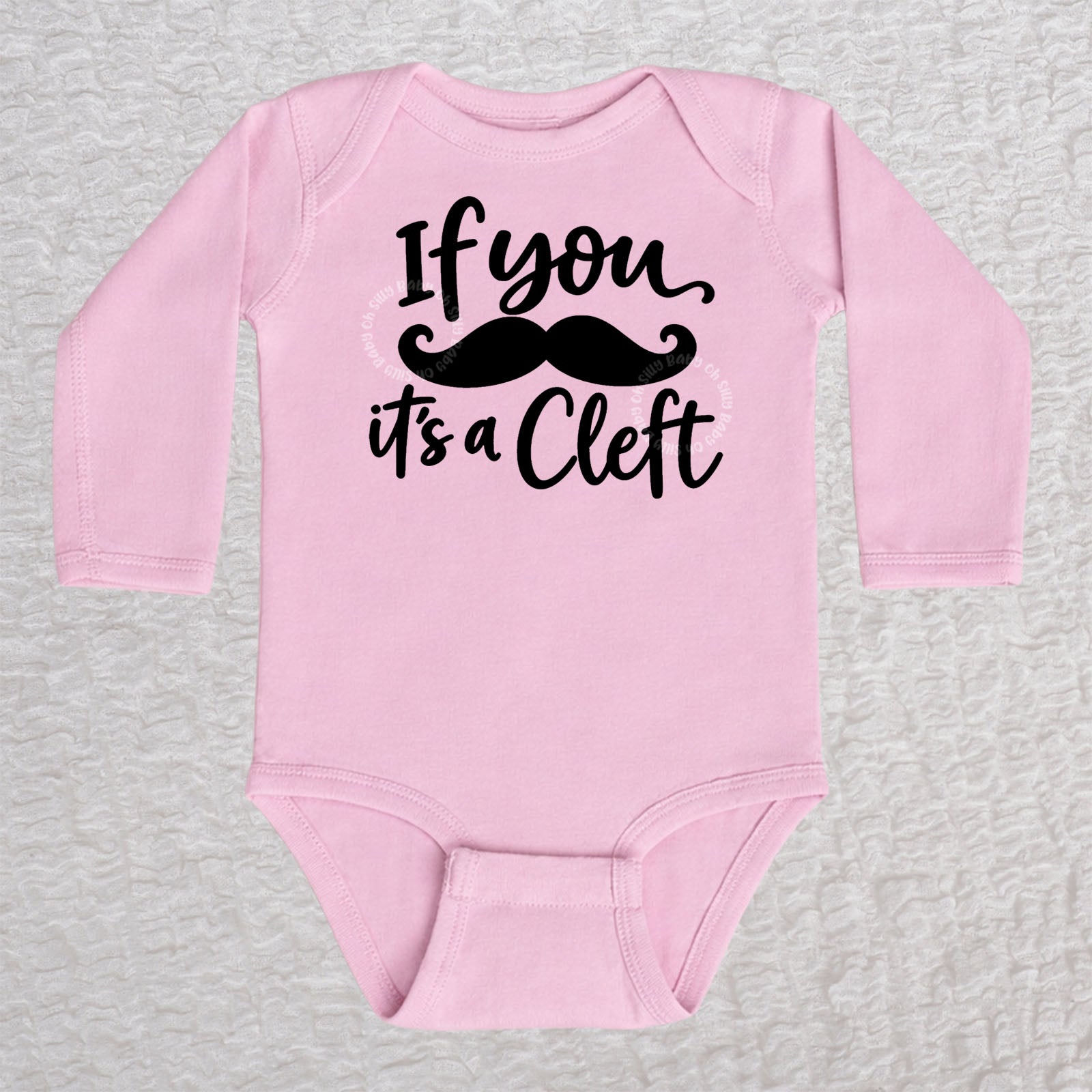 If You Mustache It's A Cleft long sleeve baby bodysuit in pink with black mustache design