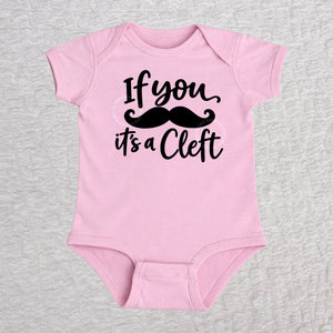 If You Mustache It's A Cleft short sleeve baby bodysuit in pink with black mustache design