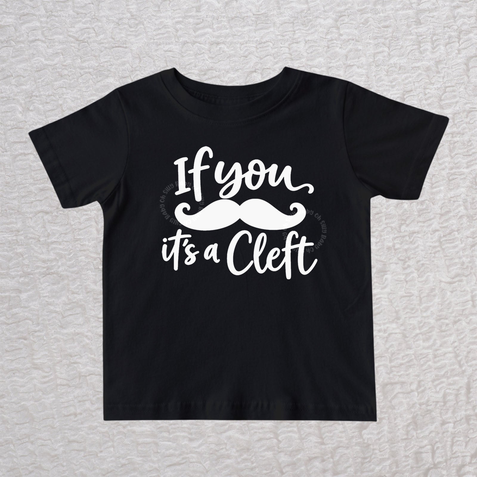 If You Mustache It's A Cleft unisex baby and toddler T-shirt in black with white mustache design