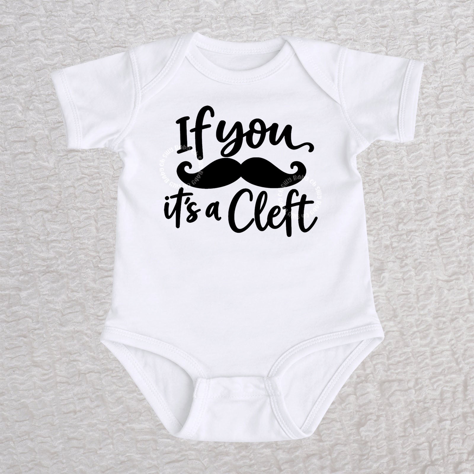 If You Mustache It's A Cleft short sleeve baby bodysuit in white with black mustache design