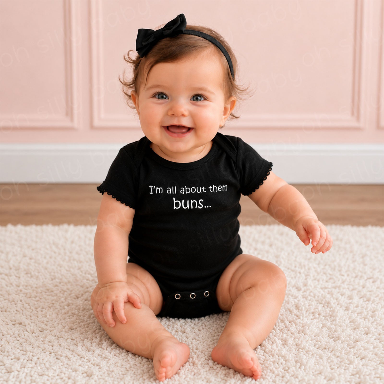 Baby girl wearing the I'm All About Them Buns black baby bodysuit