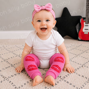 Baby wearing a white short sleeve bodysuit with Kisses baby leg warmers