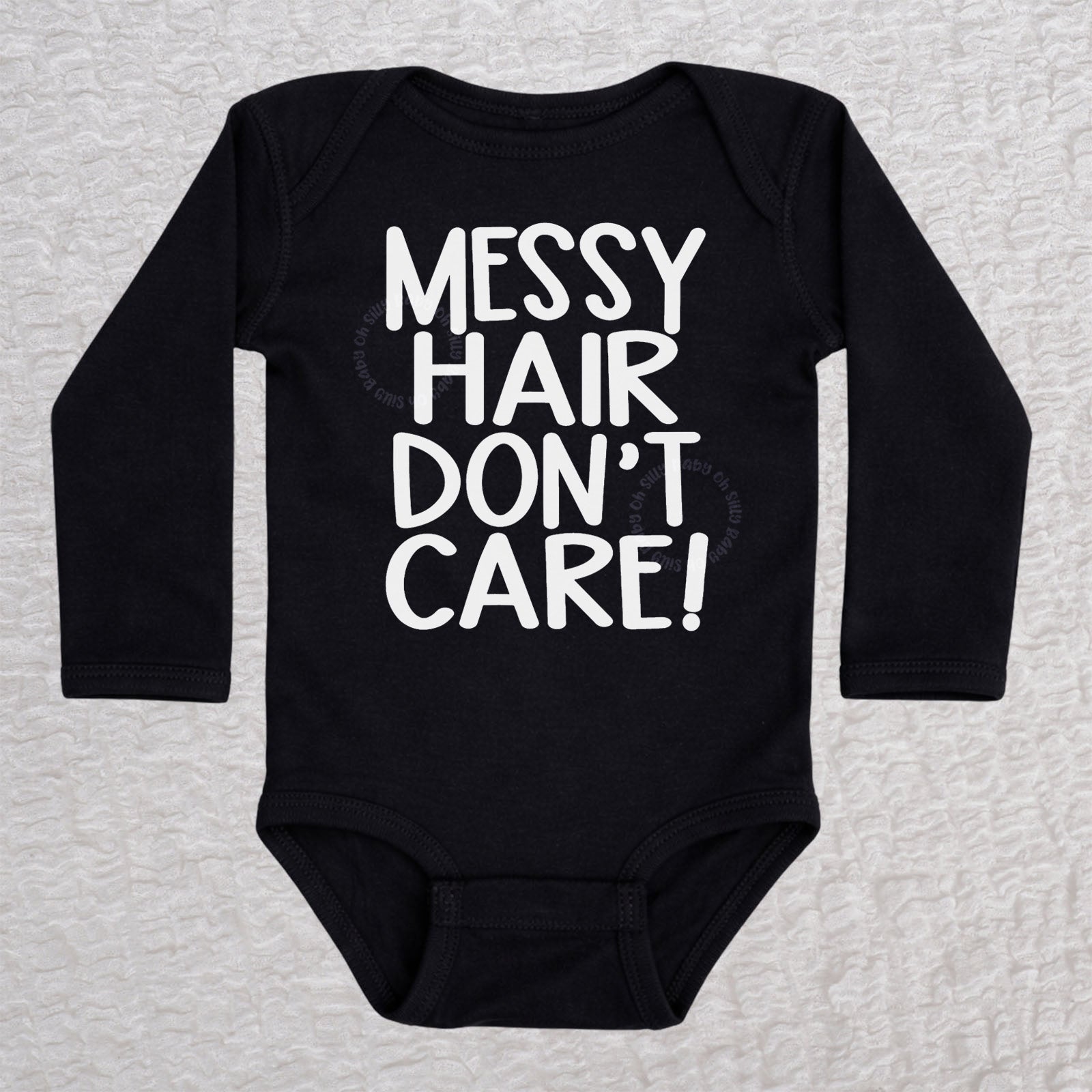 Messy Hair Don't Care long sleeve baby bodysuit in black with playful typography design
