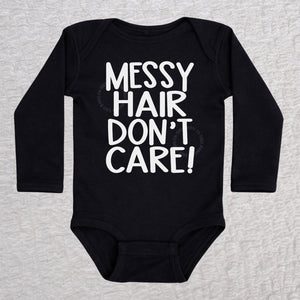 Messy Hair Don't Care long sleeve baby bodysuit in black with playful typography design