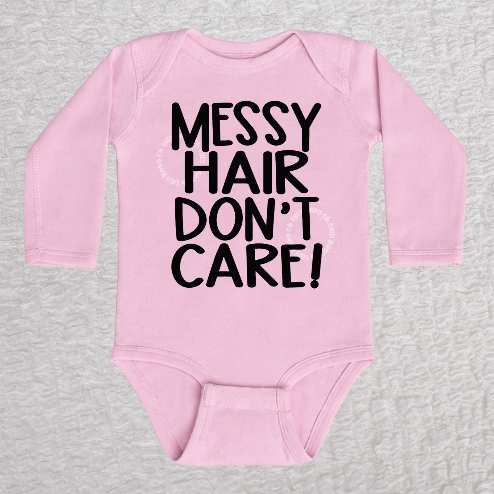 Messy Hair Don't Care long sleeve baby bodysuit in pink with playful typography design