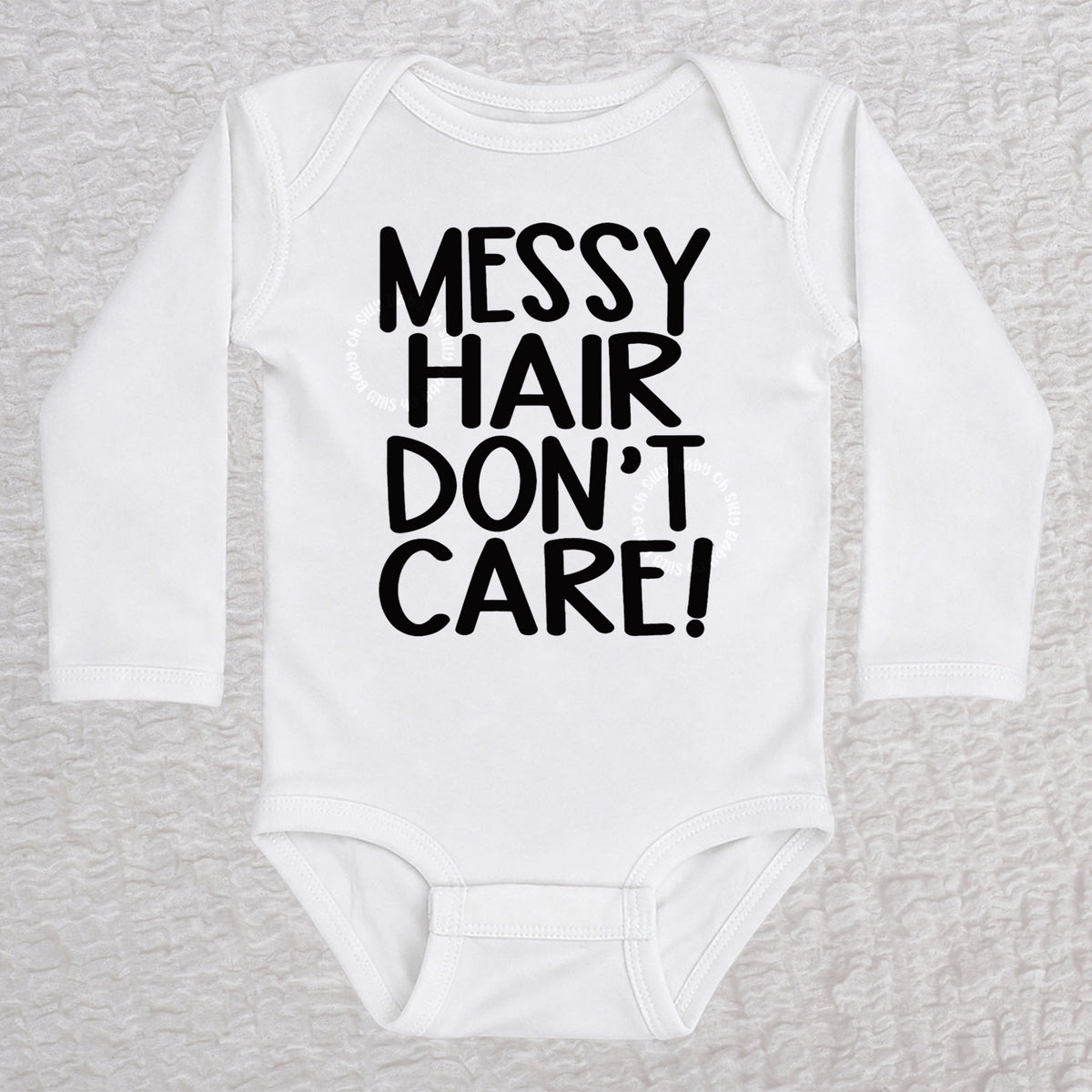 Messy Hair Don't Care long sleeve baby bodysuit in white with playful typography design