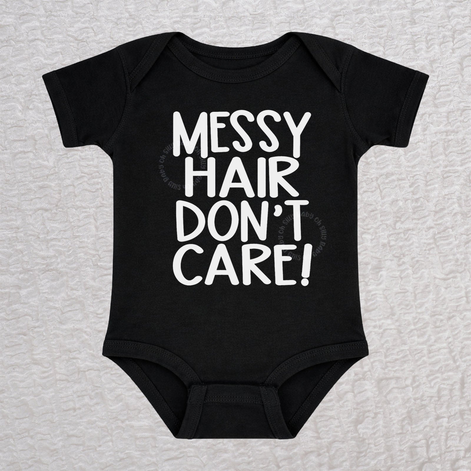 Messy Hair Don't Care short sleeve baby bodysuit in black with playful typography design