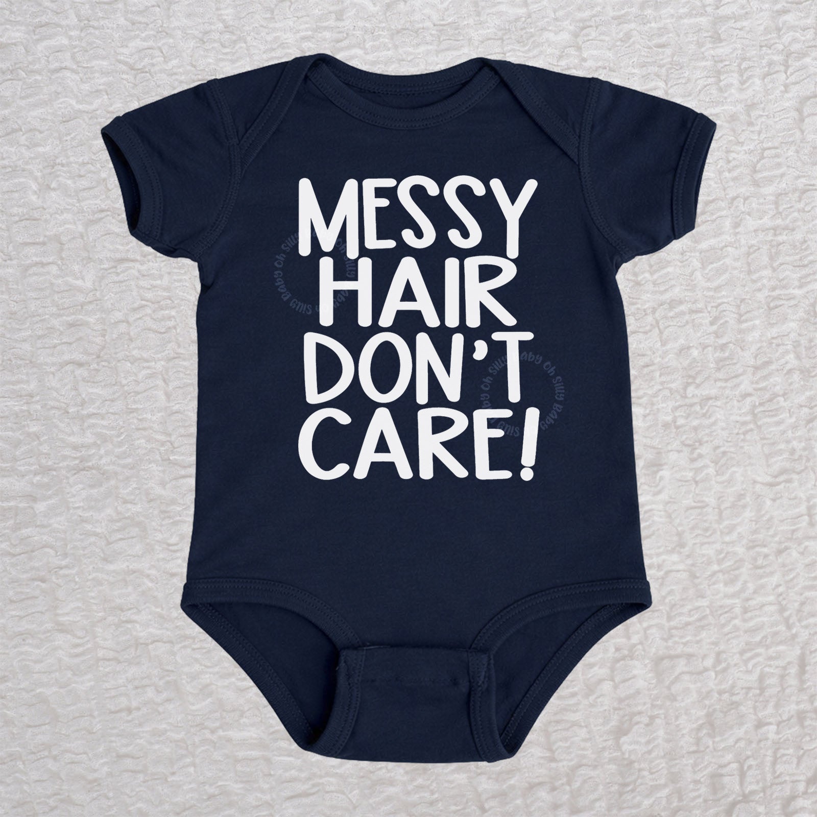Messy Hair Don't Care short sleeve baby bodysuit in navy with playful typography design