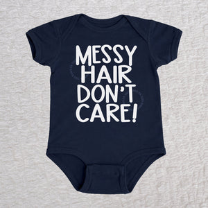 Messy Hair Don't Care short sleeve baby bodysuit in navy with playful typography design